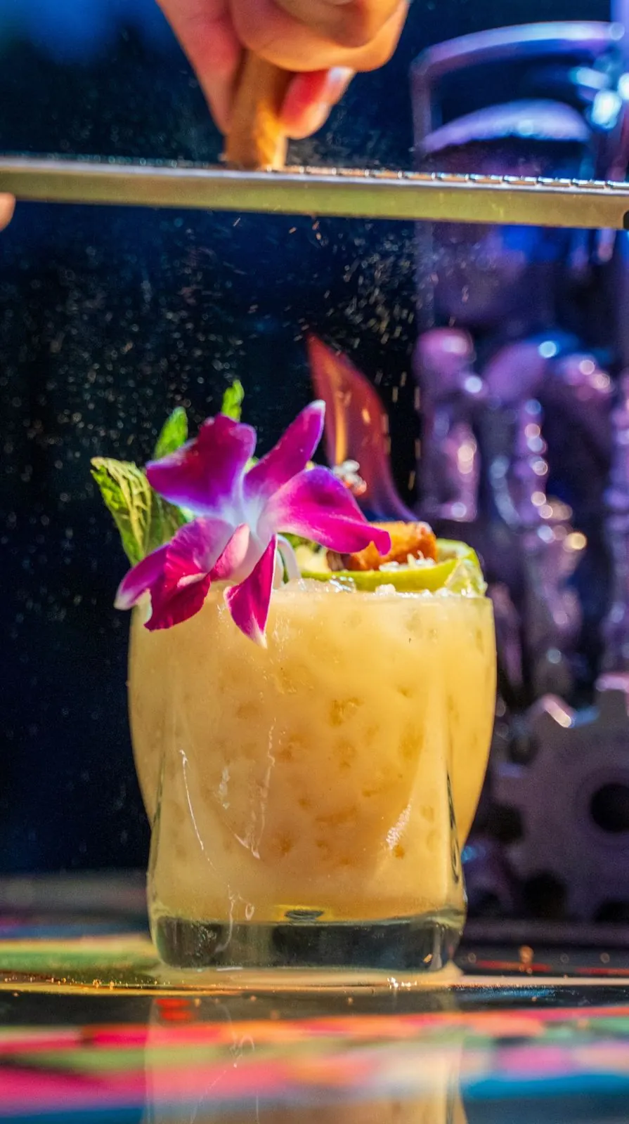 A Pistachio Mai Tai with an orchid